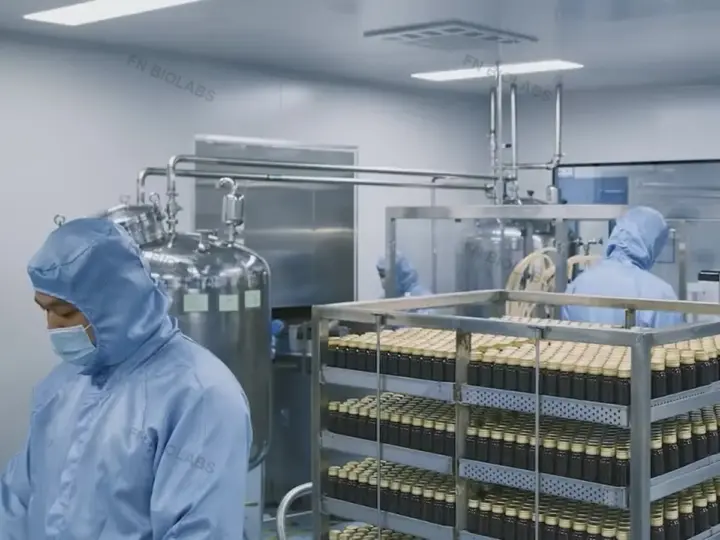 Operators preparing product containers in a controlled packaging room