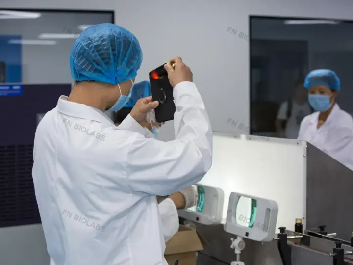 Operator carrying out a visual check beside a production line